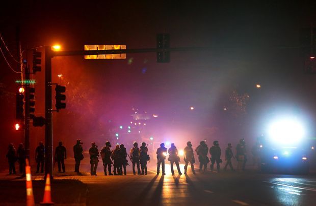 Tear gas fired, demonstrators cleared in Ferguson